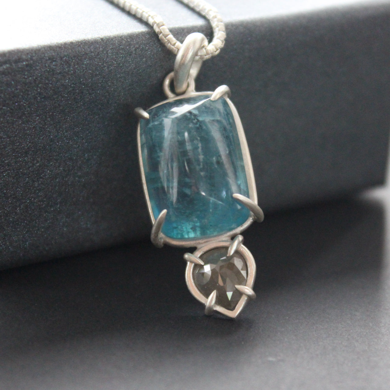 Carin Lindberg pendant with large blue aquamarine and small diamond in a silver setting