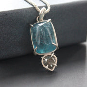 Carin Lindberg pendant with large blue aquamarine and small diamond in a silver setting