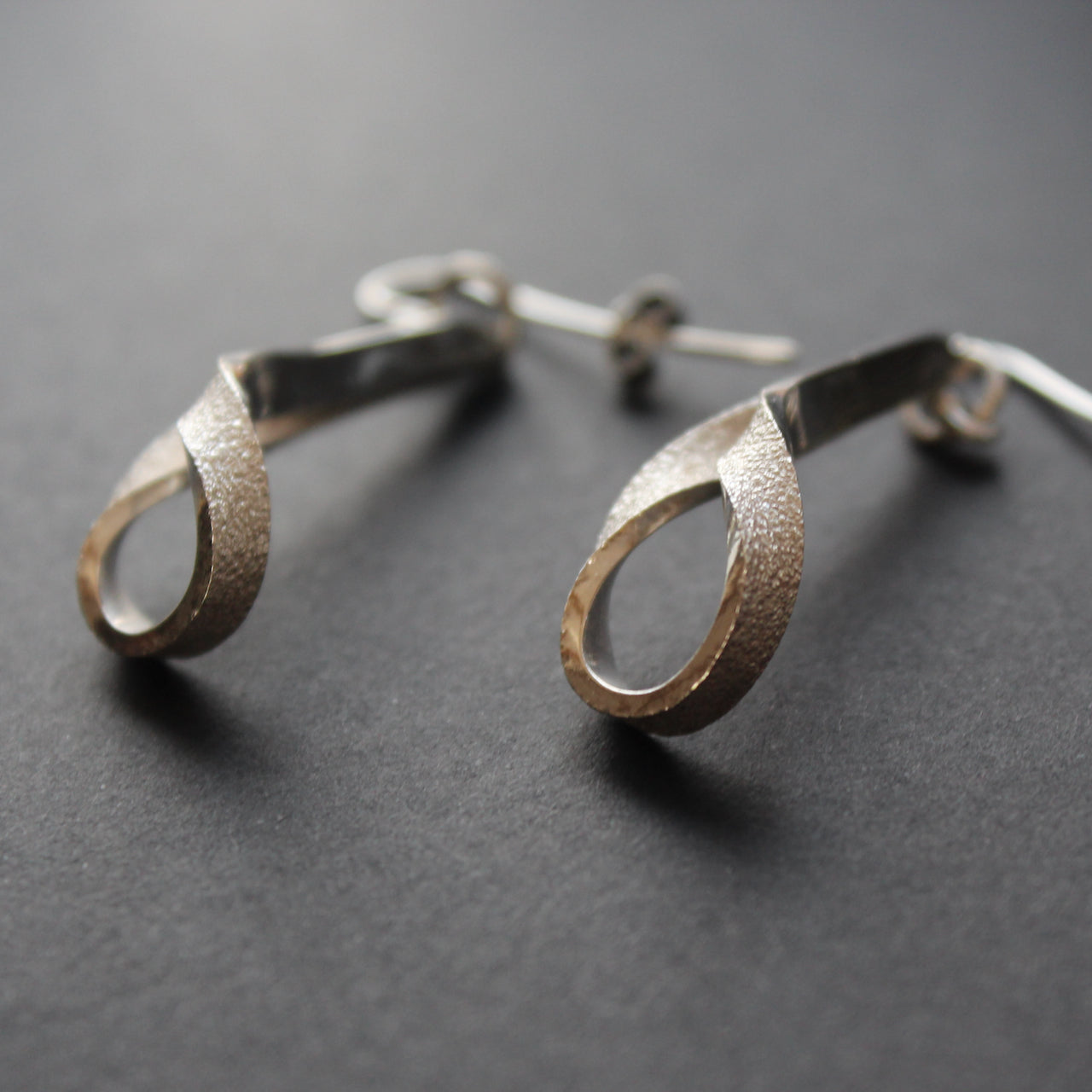 Drop silver earrings by artist Beverly Bartlett.