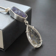 Carin Lindberg pendant with large purple opal and a diamond shaped clear stonein a silver setting