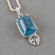 a Carin Lindberg pendant with large blue aquamarine and small diamond in a silver setting.