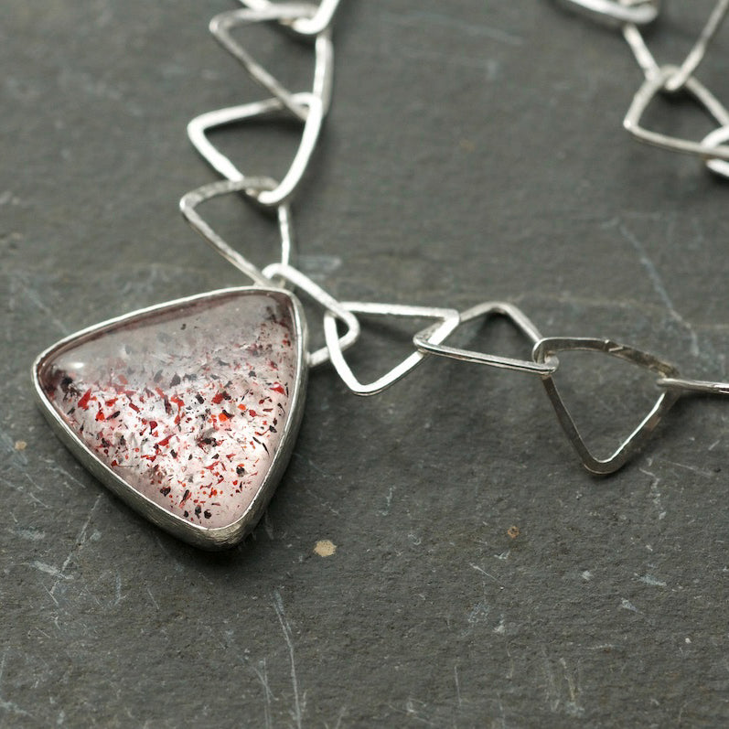 Silver triangle link necklace with triangle Fire Quartz stone pendant by artist Lucy Spink.