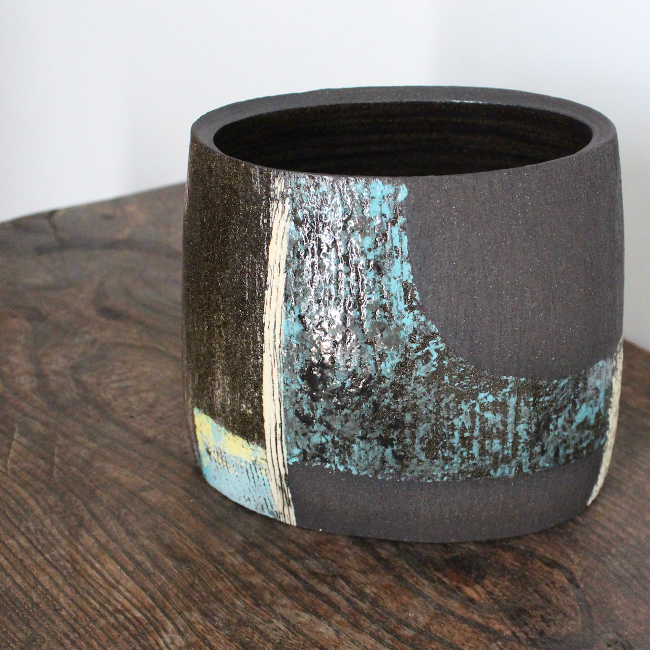 A hand built vessel with blue and white glaze on dark brown clay by Cornish Artist Anthea Bowen