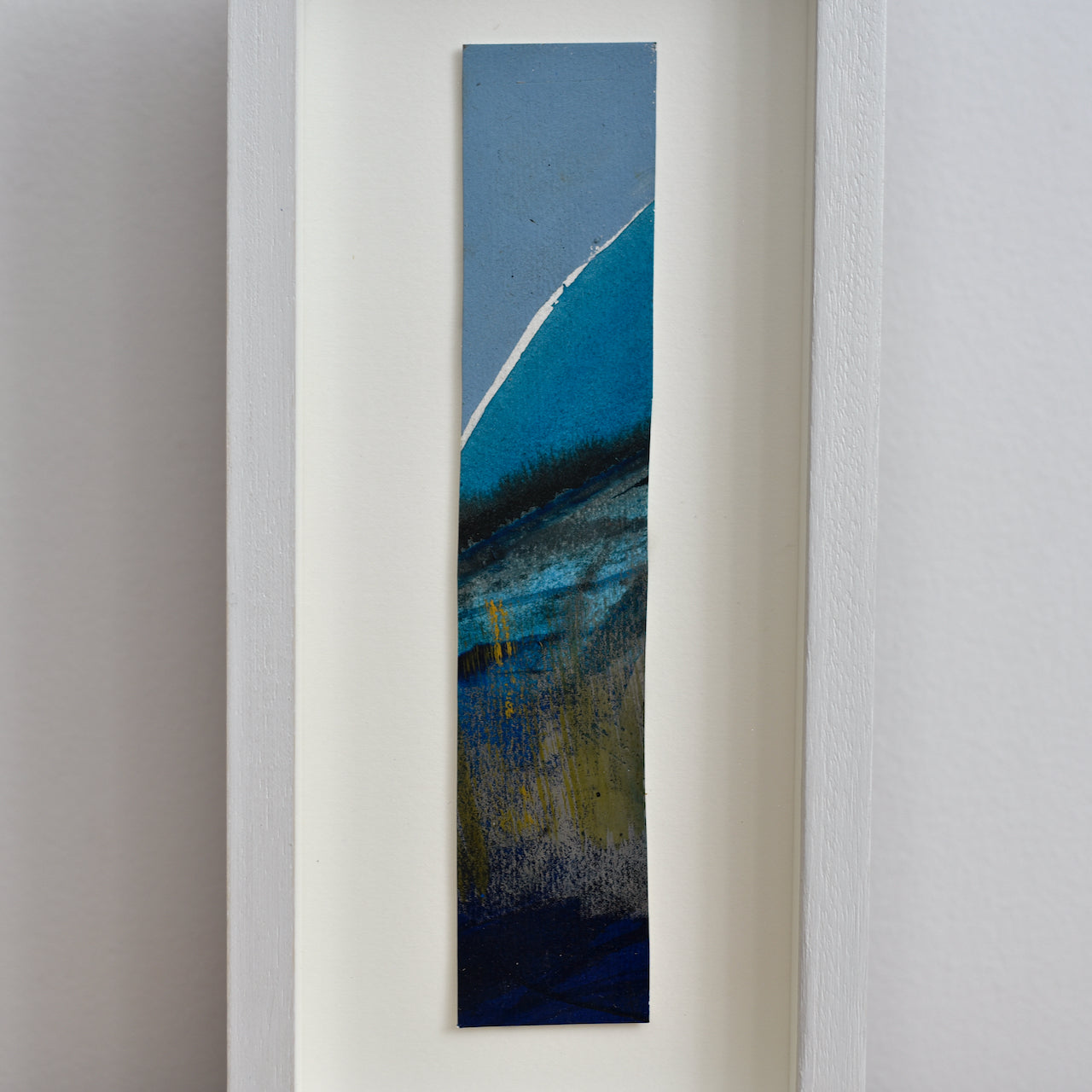 Abstract portrait picture of headland in dark blues and ochre with blue sky by UK artist Alice Robinson-Carter.