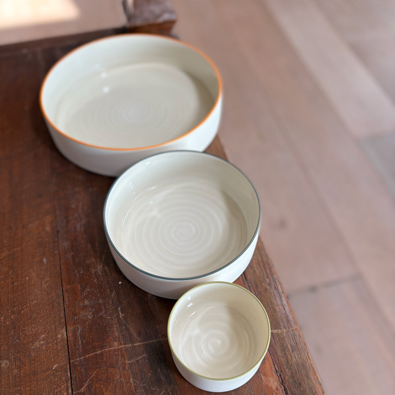 Three porcelain serving bowls in different sizes by By the Line Pottery