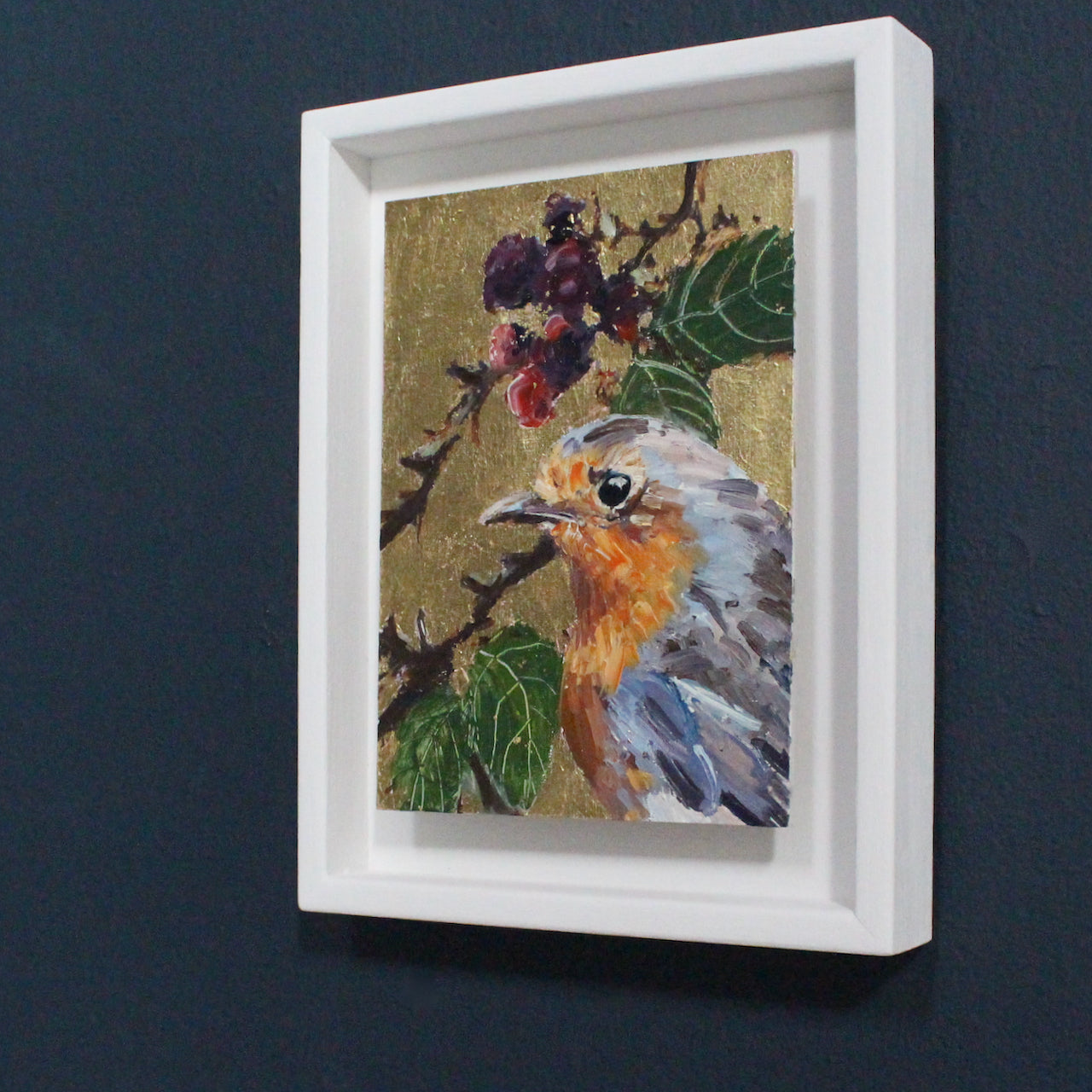 Jill Hudson painting of a robin on a gold background with green leaves and red berries 