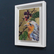 Jill Hudson painting of a robin on a gold background with green leaves and red berries