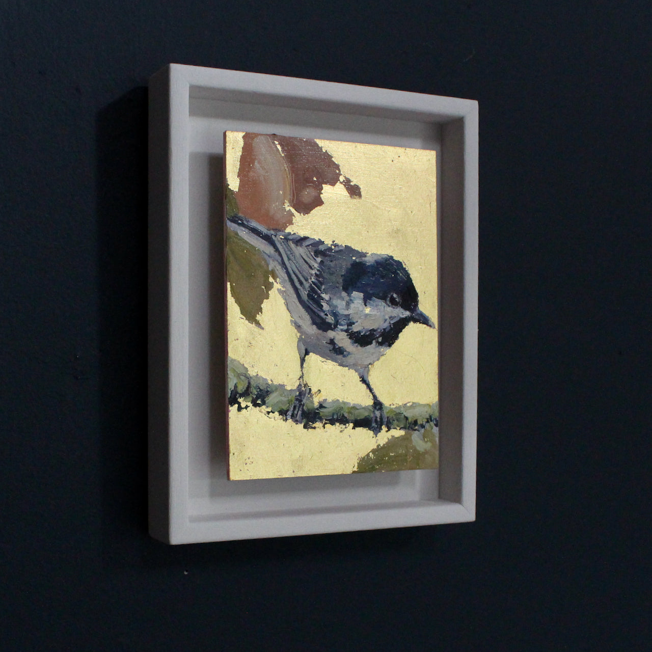 Painting by Cornwall artist Jill Hudson of coaltit on a branch with orange and yellow leaves against a gold background 