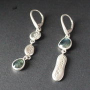 Carin Lindberg silver and teal sapphire drop earrings the sapphire is an a different position on each earring 