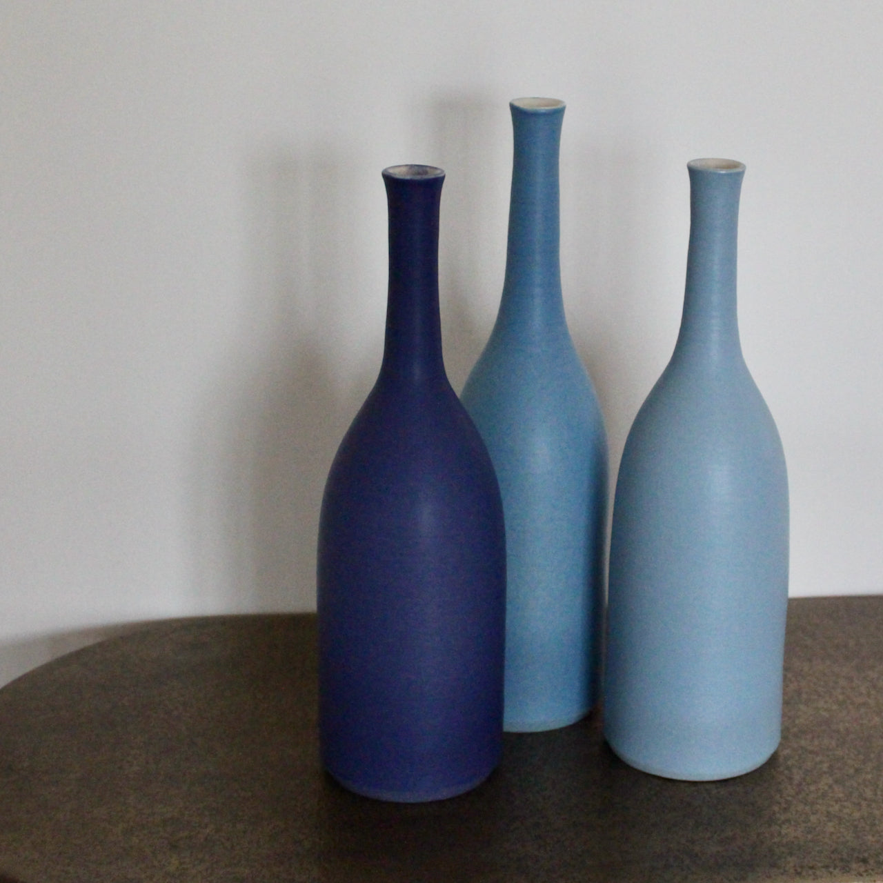 trio of blue ceramic bottles by ceramic artist Lucy Burley.