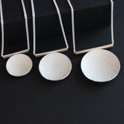 three Textured silver round pendants by Beverly Bartlett