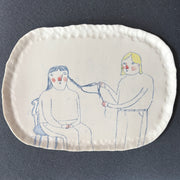 Becca Brown ceramic plaque with line drawing of two women, one putting plaits in the others hair