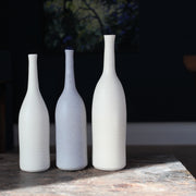 three ceramic bottles in pale, neutral shades by UK ceramicist Lucy Burley.
