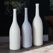 a trio of ceramic bottles in pale, neutral shades by UK ceramic artist Lucy Burley.