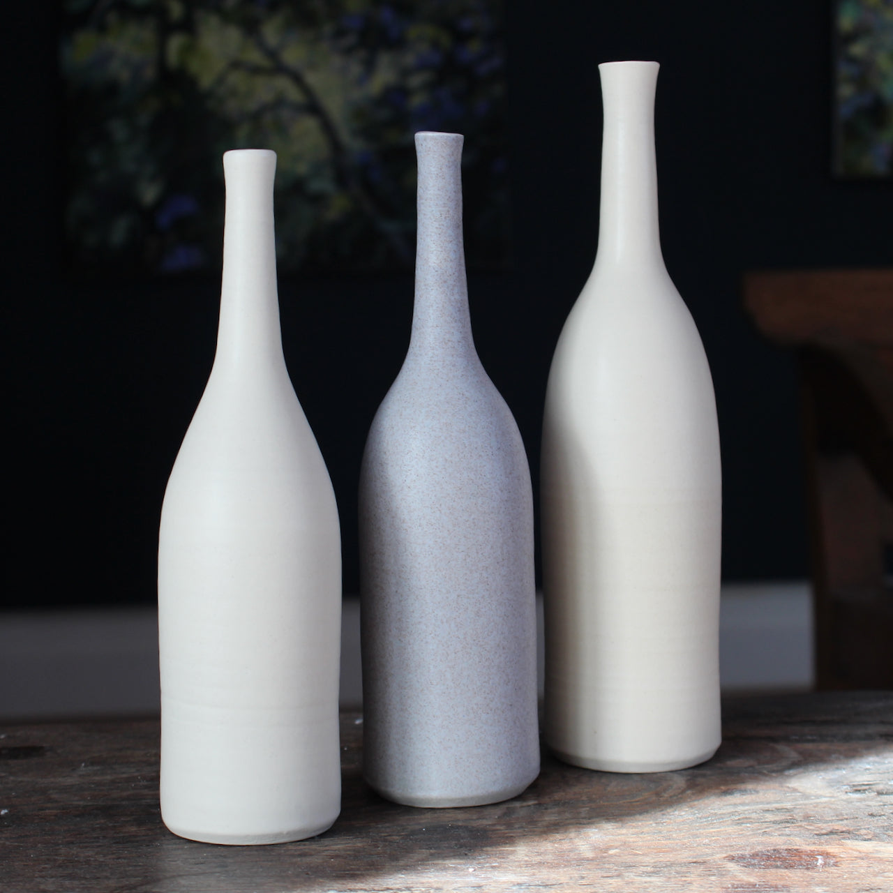 a trio of ceramic bottles in pale, neutral shades by UK ceramic artist Lucy Burley.