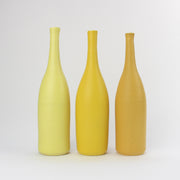 a trio of  ceramic bottles in shades of yellow by UK ceramicist Lucy Burley