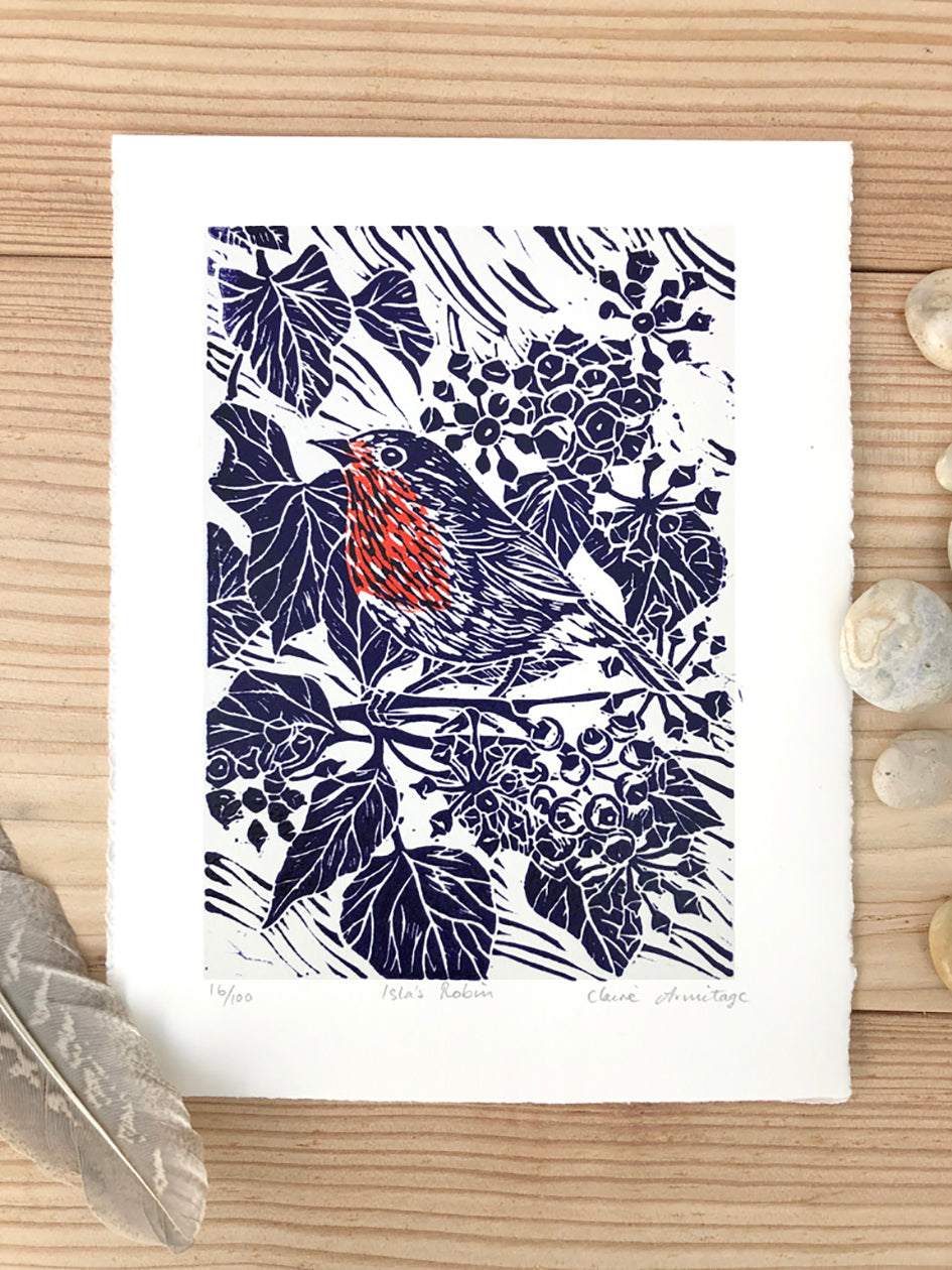Blue & red robin lino print by artist Claire Armitage.