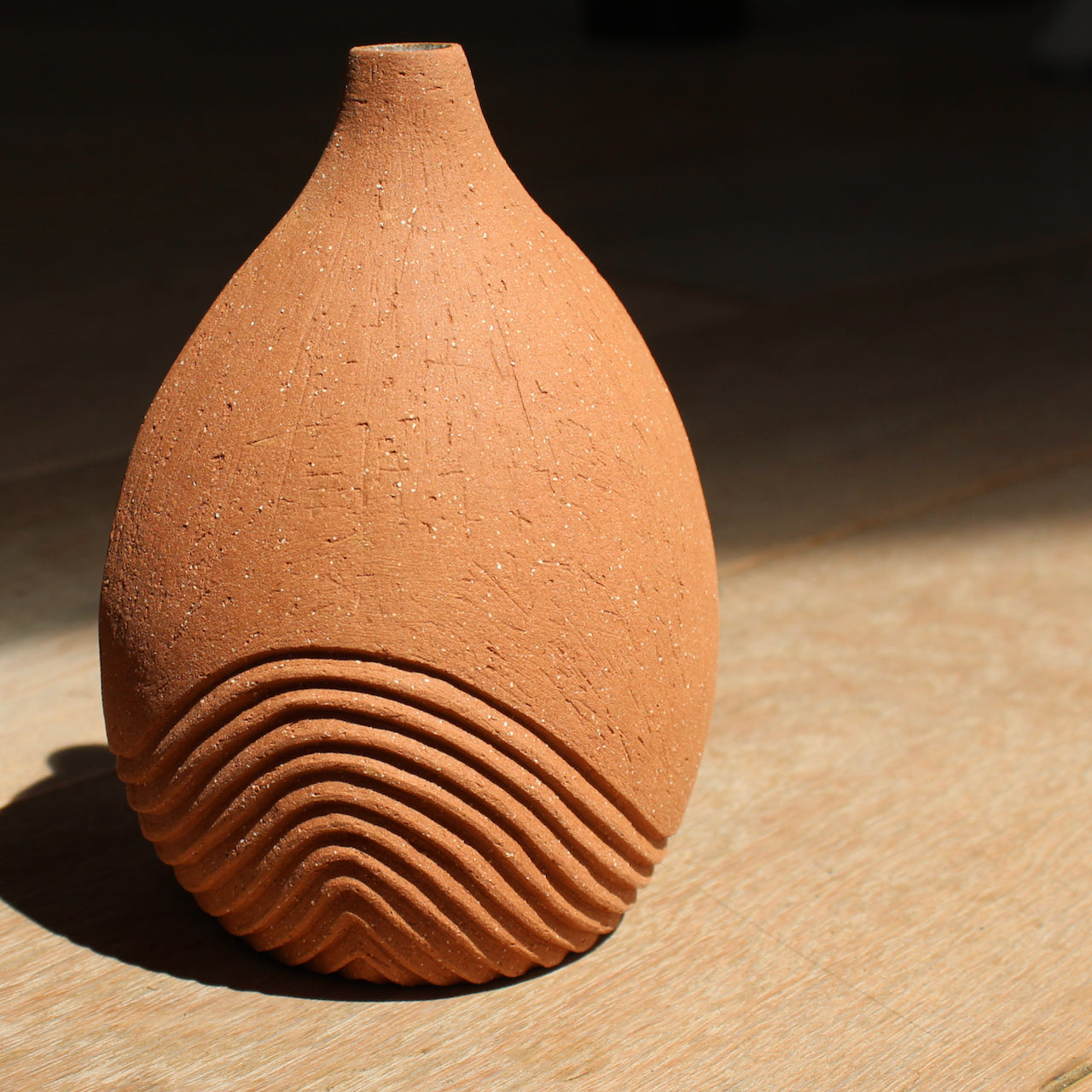 Artist Michele Bianco, hand carved, tinted stoneware medium sized mid terracotta bottle with line detail