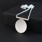 Textured silver round pendant by Beverly Bartlett
