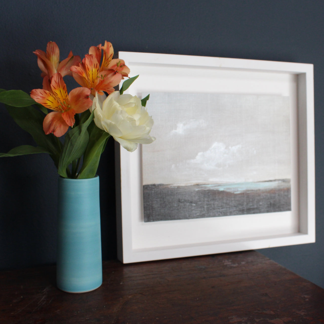 Cornish artist Nicola Mosley, Seascape of dark shore with blue sea and white clouds