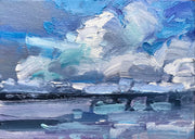 Blue & white clouds over blue and turquoise ocean by artist Jill Hudson