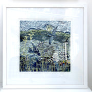 Lino print by artist Claire Armitage of swallows over lake in blue and yellow tones
