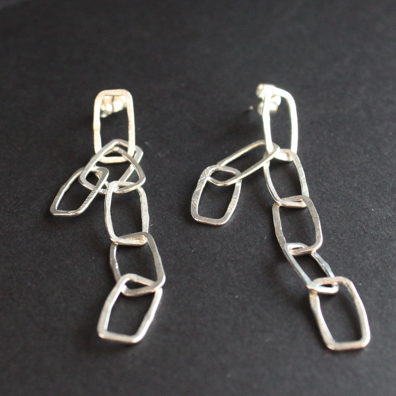 Silver mini monolith shape chain earrings by Cornish artist Lucy Spink.