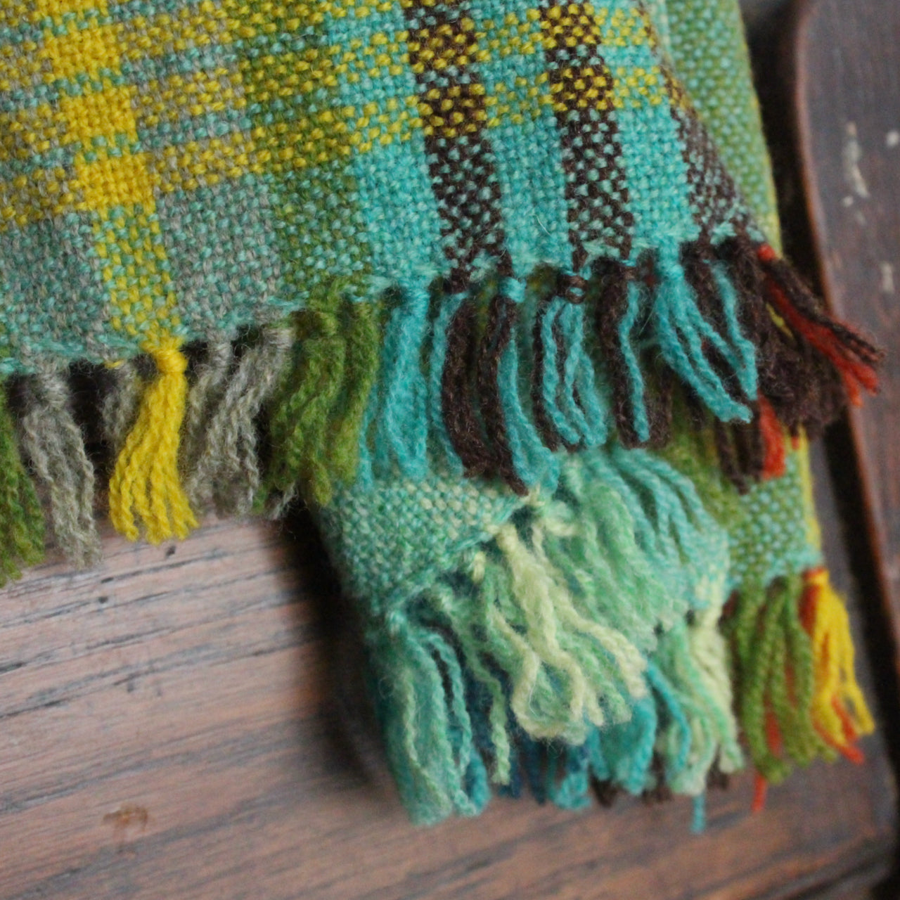 close up detail of scarf by Teresa Dunne Cornish weaver in turquoise, green and yellow 