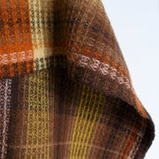 close up detail of handwoven woollen scarf by Teresa Dunne Cornish weaver in pink, cream, brown and orange.