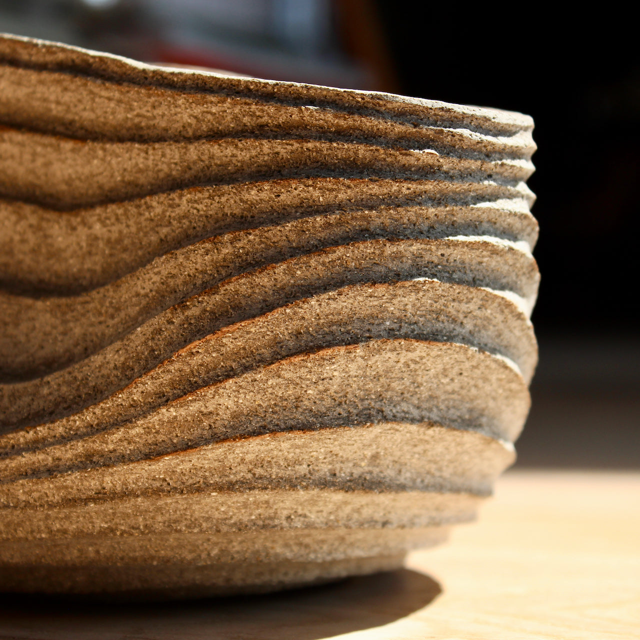 close up detail of the carving of a slumped carved with rib design stoneware bowl by UK ceramic artist Michele Bianco