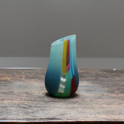 small glass vase in blue, green and pink with an angled top made by Welsh glass artist Ruth Shelley