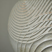 close up of Michele Bianco pale white stoneware ceramic disc shaped vessel with carved overlapping lines.