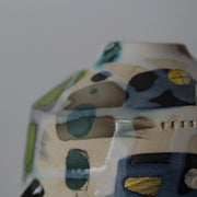 close up detail of a ceramic bottle in yellow, grey and green by UK potter Dawn Hajittofi