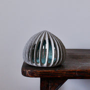 pale green carved and semi open stoneware ceramic pod shaped sculpture by Michele Bianco.