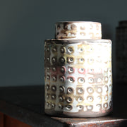 a  textured ceramic vessel in pinks, blues and mustard by UK ceramicist Elly Wall.
