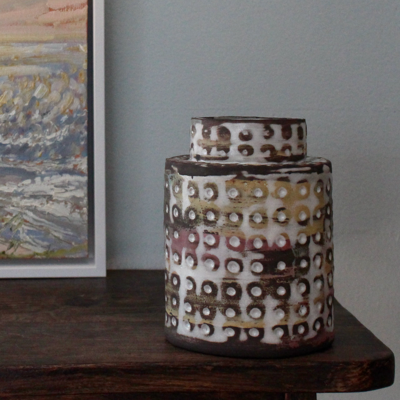 textured ceramic vessel in pinks, blues and mustard by UK potter Elly Wall