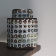 a  textured ceramic vessel in brown, blues and green by UK ceramicist Elly Wall.
