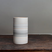 white ceramic vase with pale orange and grey stripes