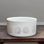 white porcelain serving dish decorated with abstract black circles