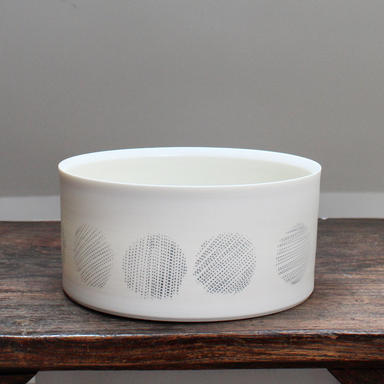 white porcelain serving dish decorated with abstract black circles