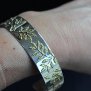 Plantae bangle in silver with gold leaf detail by Beverly Bartlett on wrist