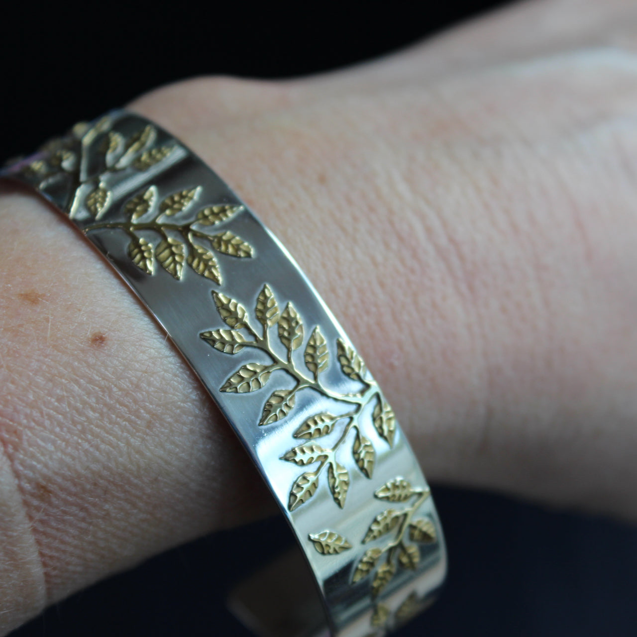 Plantae bangle in silver with gold leaf detail by Beverly Bartlett on wrist