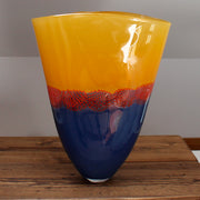 glass vessel by Benjamin Lintell with a blue base and orange top divided by a red detail at the Byre gallery