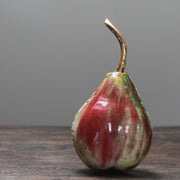 ceramic red and green pear and a gold stalk by Remon Jephcott