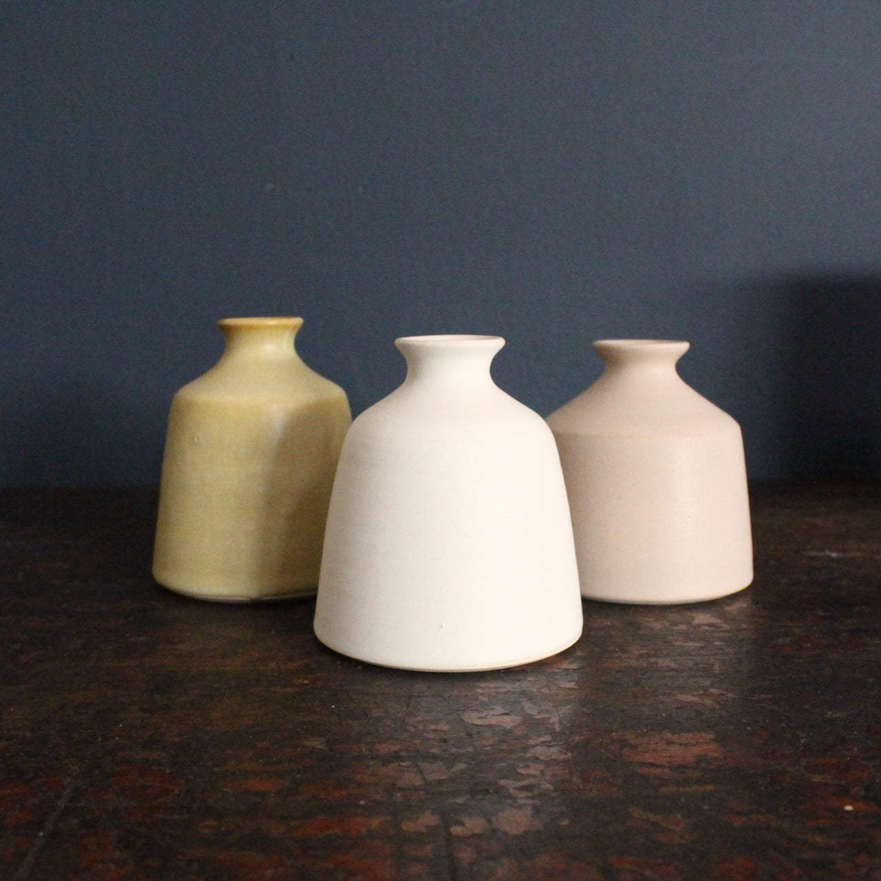 white, yellow and pale pink bud vases by EOT ceramics 