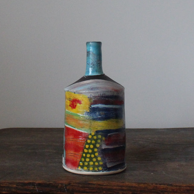 multi-coloured ceramic bottle with a thin blue neck by potter John Pollex.