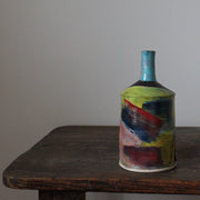 multi-coloured ceramic bottle with a blue neck by potter John Pollex