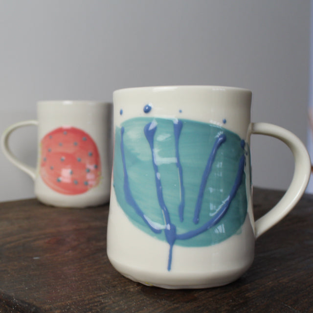 a pair of porcelain decorated mugs by Helen Harrison