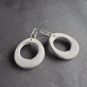 oval shaped pale grey earrings with hole in the middle  by jewellery designer Clare Lloyd
