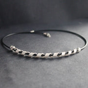 a silver helix twisted necklace on black leather band by Beverly Bartlett, UK jewellery designer